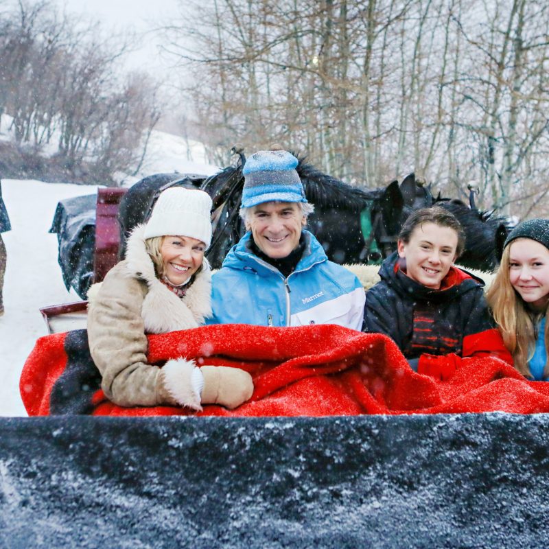 a group of people sitting in the snow