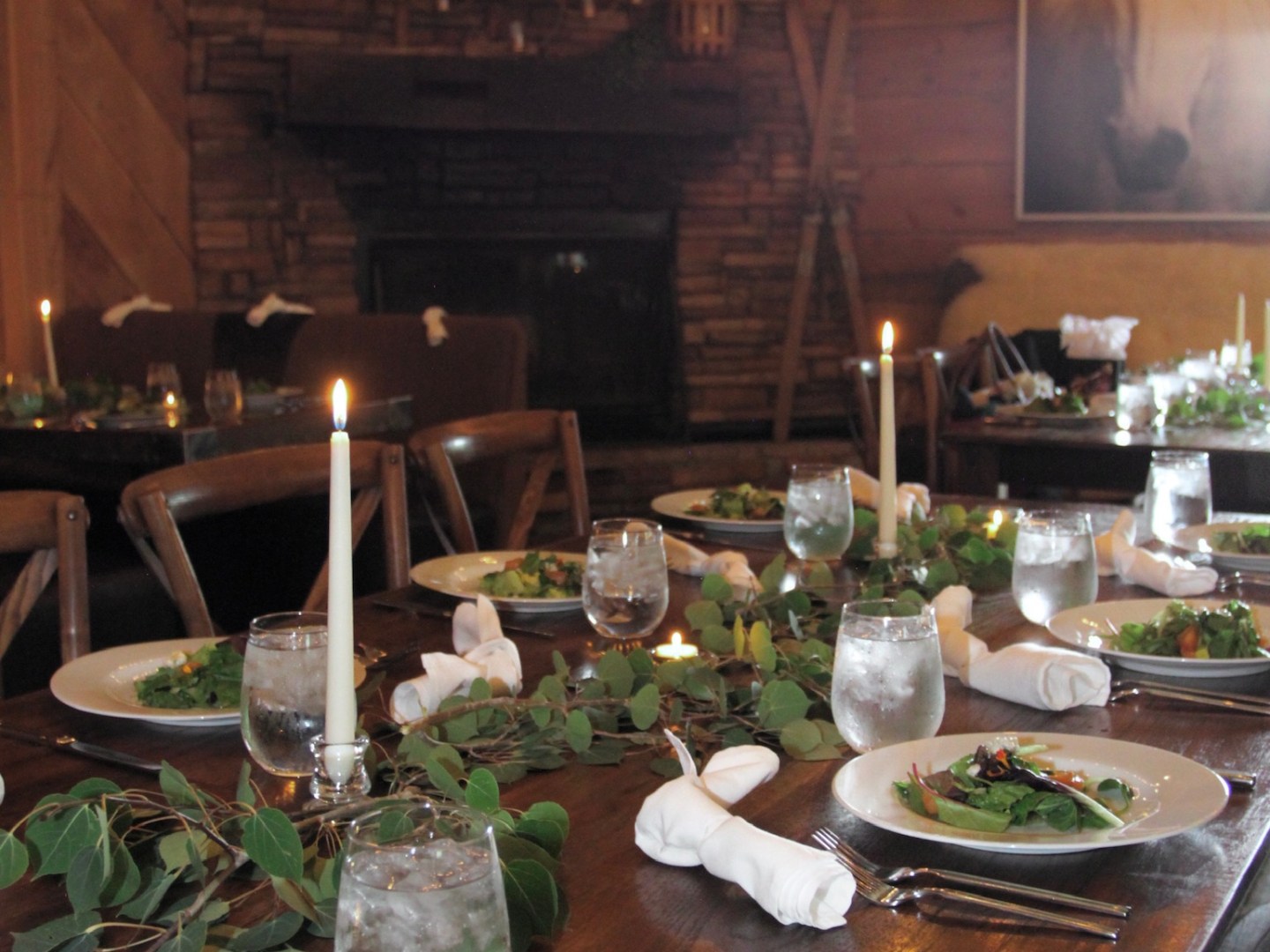 a plate of food and glasses of wine on a table