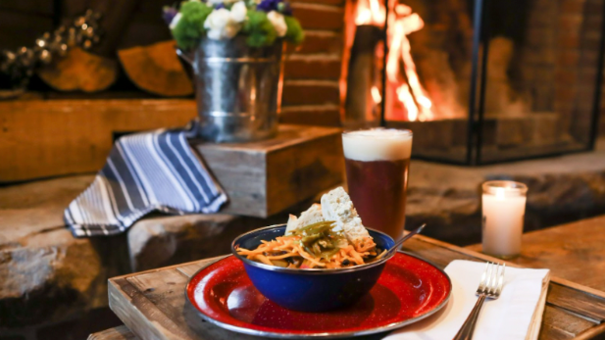 a wooden table topped with plates of food