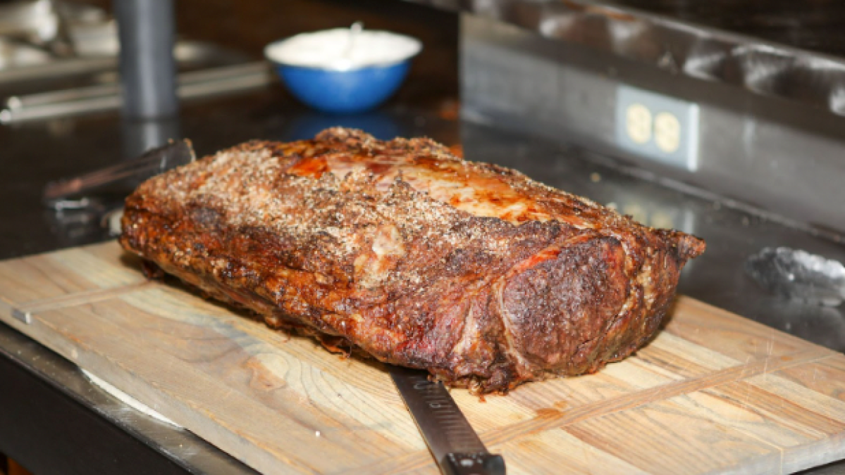 a pizza sitting on top of a wooden cutting board